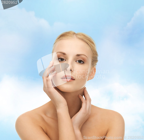 Image of woman touching her face skin