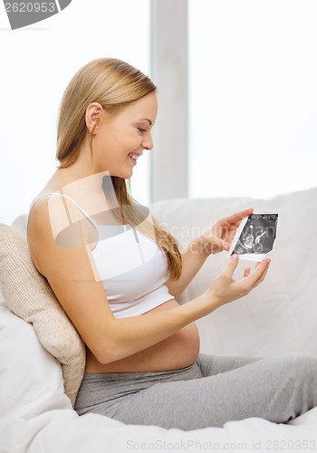 Image of happy pregnant woman with ultrasound picture