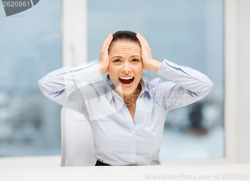 Image of angry screaming businesswoman in office