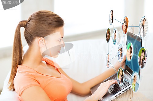 Image of woman using laptop at home