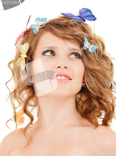 Image of happy teen girl with butterflies in hair