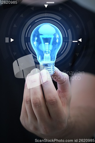 Image of close up of man hand holding light bulb