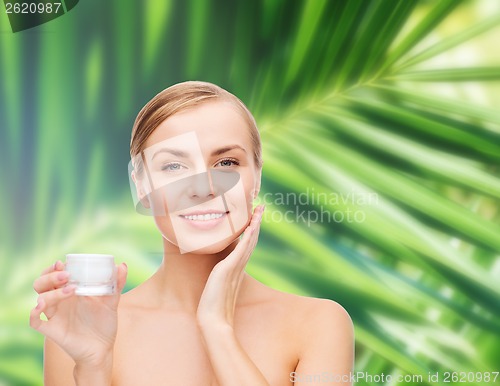 Image of woman applying cream on her skin