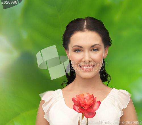 Image of young and beautiful woman with flower