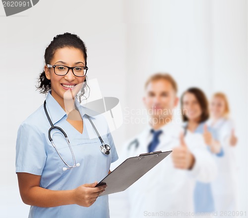 Image of smiling female african american doctor or nurse