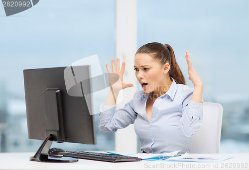 Image of stressed woman with computer