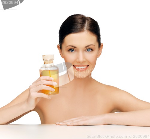 Image of beautiful woman with oil bottle