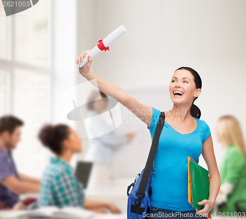 Image of smiling student with bag and folders