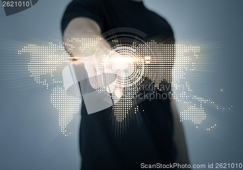 Image of man pointing his finger at world map