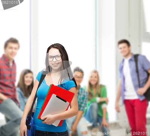 Image of smiling student with bag, folders and tablet pc