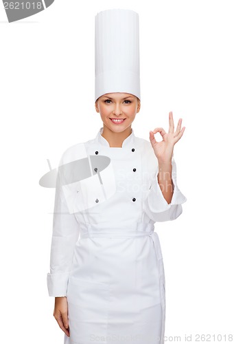 Image of smiling female chef showing ok hand sign