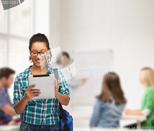 Image of student in eyeglasses with tablet pc and bag