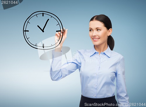 Image of businesswoman drawing clock in the air