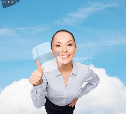 Image of smiling asian businesswoman showing thumbs up