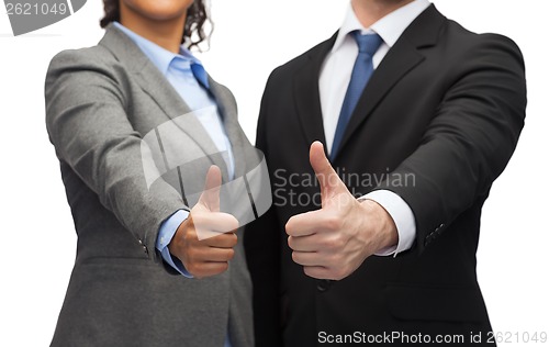 Image of businessman and businesswoman showing thumbs up