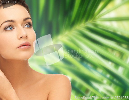 Image of woman touching her face skin
