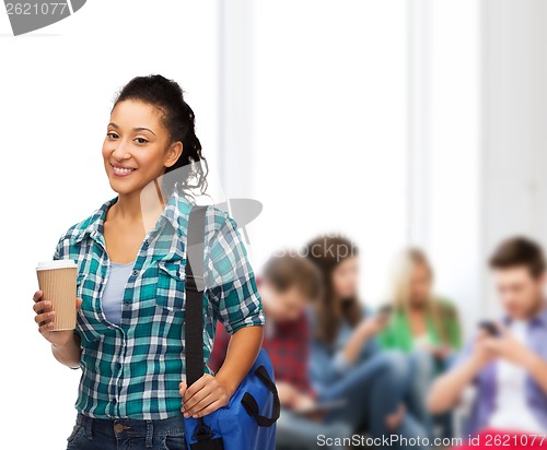 Image of smiling student with bag and take away coffee cup