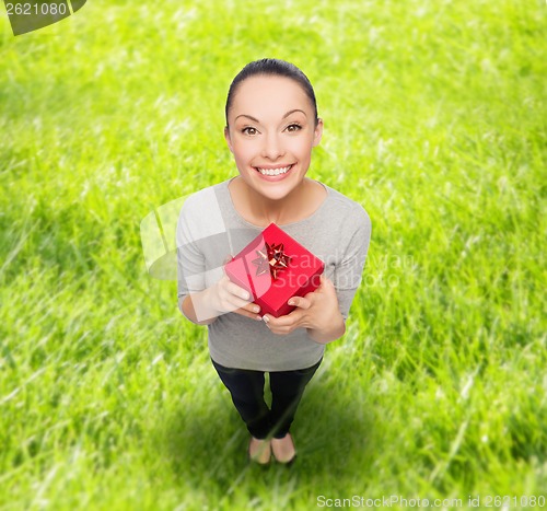 Image of smiling asian woman with red gift box