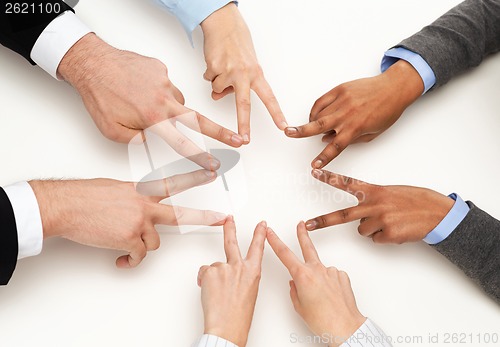 Image of group of businesspeople showing v-sign