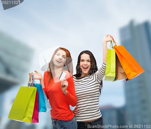 Image of teenage girls with shopping bags and credit card