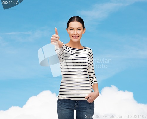 Image of smiling girl in casual clother showing thumbs up