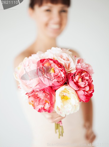 Image of woman hands with bouquet of flowers