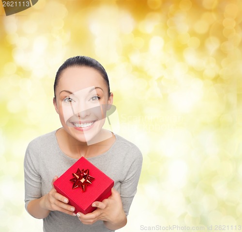 Image of smiling asian woman with red gift box