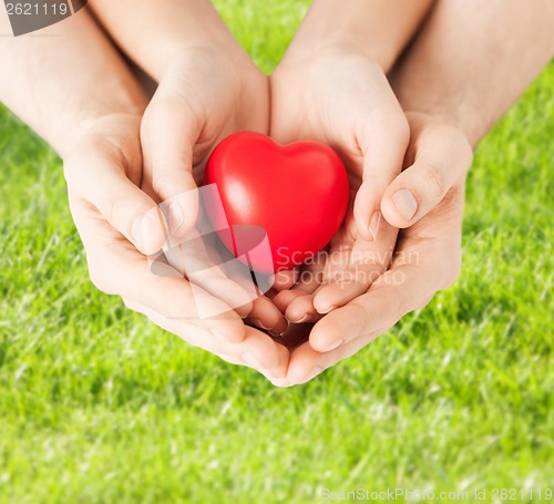 Image of woman and man hands with heart