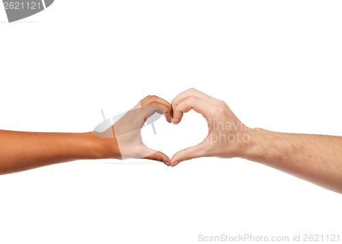 Image of woman and man hands showing heart shape