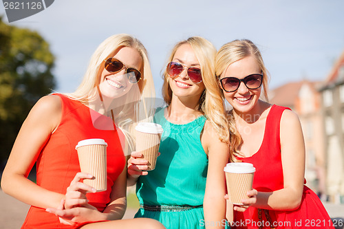 Image of women with takeaway coffee cups in the city