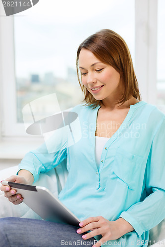 Image of happy woman with tablet pc computer at home