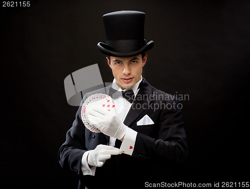 Image of magician showing trick with playing cards