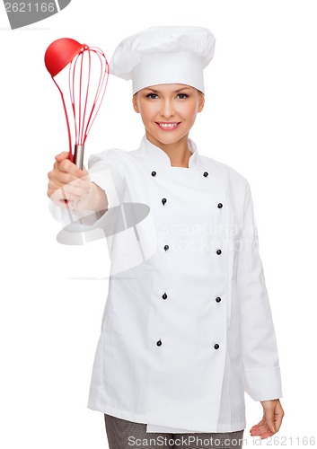 Image of smiling female chef with cooking equipment