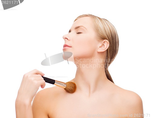 Image of beautiful woman with makeup brush