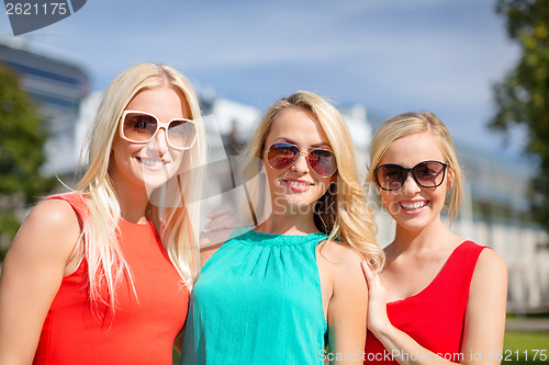 Image of three beautiful women in the city