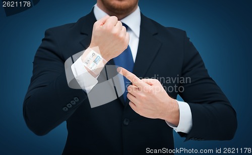 Image of businessman pointing to something at his hand