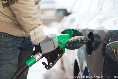 Image of close up of male refilling car fuel tank