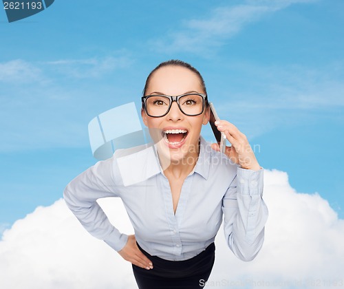 Image of happy businesswoman in eyeglasses with smartphone