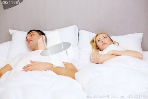 Image of happy couple sleeping in bed