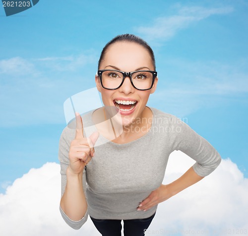 Image of asian woman in eyeglasses with finger up