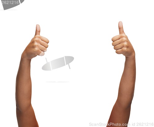 Image of woman hands showing thumbs up