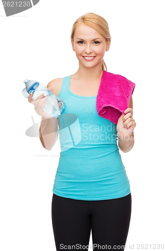 Image of sporty woman with towel and watel bottle