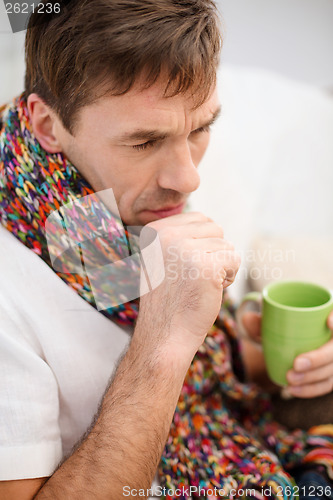 Image of ill man with flu at home