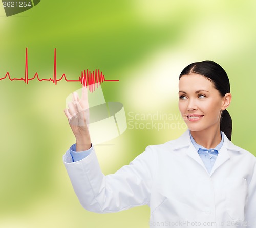 Image of smiling female doctor pointing to cardiogram