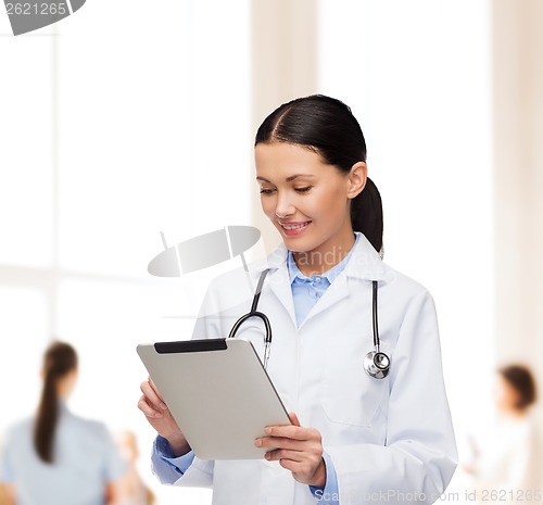 Image of female doctor with stethoscope and tablet pc
