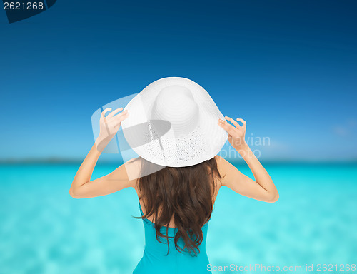 Image of model in swimsuit with hat