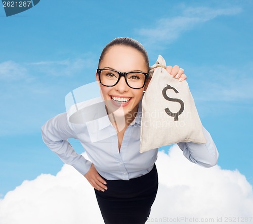 Image of happy businesswoman holding money bag with dollar