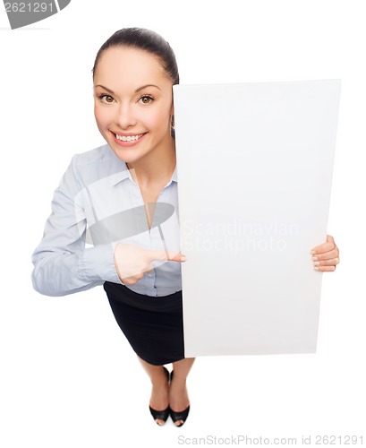 Image of businesswoman pointing to white blank board