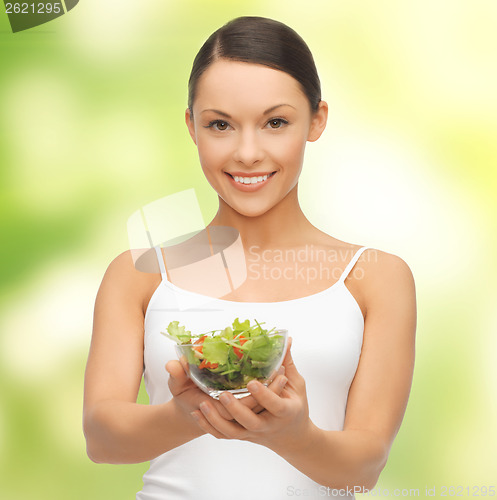 Image of healthy woman holding bowl with salad