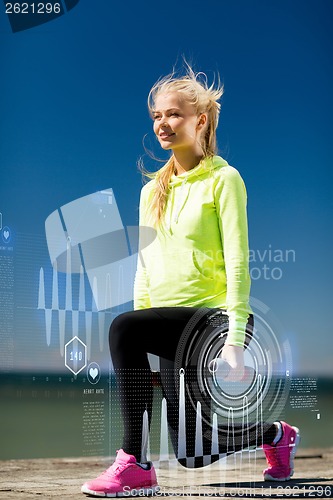 Image of sporty woman with light dumbbells outdoors